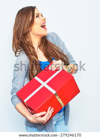 Surprising Woman hold big  gift box. Big smile with teeth. Emotion of happy woman. White wall background. Red gift box. 
