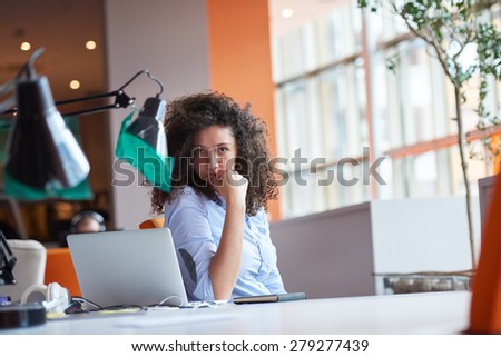 happy young curly  business woman in the modern office