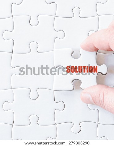 Missing jigsaw puzzle piece with word SOLUTION. Business concept image for completing the puzzle.