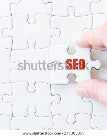 Missing jigsaw puzzle piece with word SEO. Business concept image for completing the puzzle.