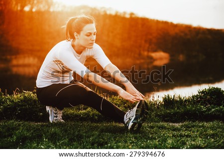 Young woman exercise in nature at the sunrise  Royalty-Free Stock Photo #279394676