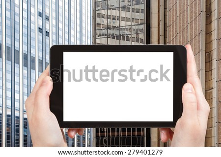 travel concept - tourist photograph tower buildings in New Your, fragment on tablet pc with cut out screen with blank place for advertising logo