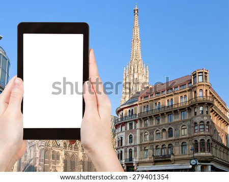 travel concept - tourist photograph towers of St Stephan Cathedral, Vienna, Austria on tablet pc with cut out screen with blank place for advertising logo