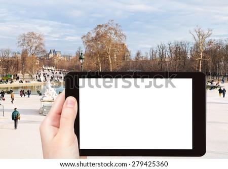 travel concept - tourist photograph Grand Basin Octagonal in Tuileries Garden, Paris, France on tablet pc with cut out screen with blank place for advertising logo 