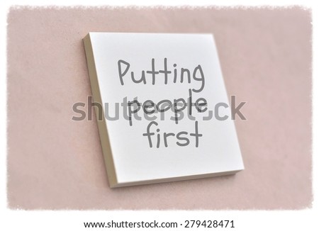 Text putting people first on the short note texture background
