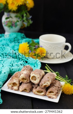 Cookies rolls with rhubarb and cinnamon on a dark background