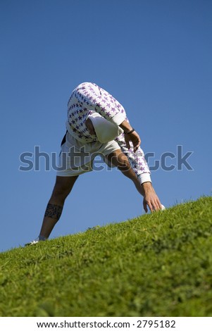 healthy lifestyle: man doing stretching in a park