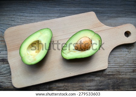 Healthy green avocado on wooden table