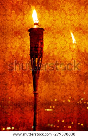 Vintage textured picture of glowing torch against a surface with reflections of lights (texture added, grunge effect image, toned red, retro styled)