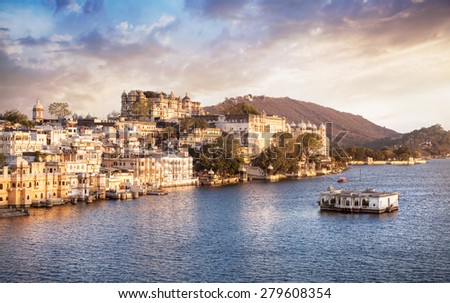 Lake Pichola with City Palace view at cloudy sunset sky in Udaipur, Rajasthan, India Royalty-Free Stock Photo #279608354