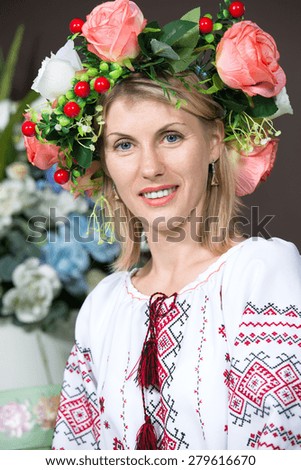 Attractive young woman in traditional Ukrainian dress. Vertical photo