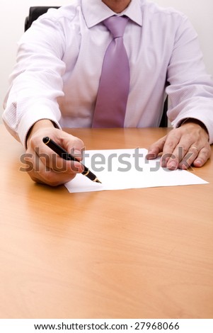 businessman offering his pen to the costumer, for signing the contract