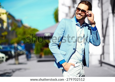 High fashion look.Young stylish confident happy handsome businessman model  in suit cloth lifestyle in the street in sunglasses Royalty-Free Stock Photo #279702512