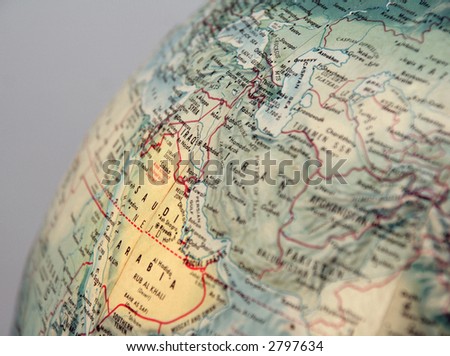 closeup of World globe focused on middle east with grey background