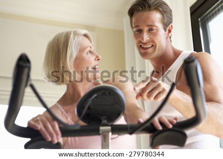 Senior Woman On Exercise Bike With Trainer