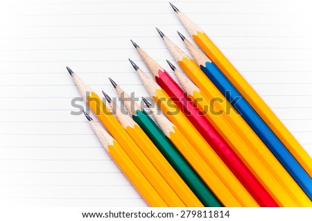 This is a back to school shot showing sharp pencils placed on notebook paper.