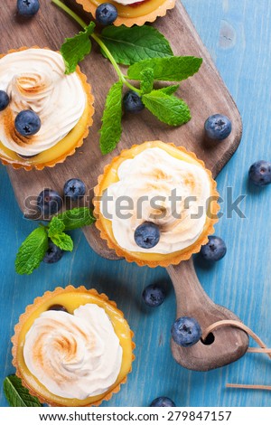 Mini lime curd tartlets with meringue. Holiday concept. Top view.