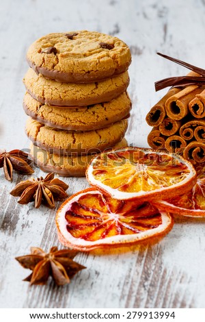 Chocolate cookies with dry oranges, anise and cinnamon on the light wooden boards