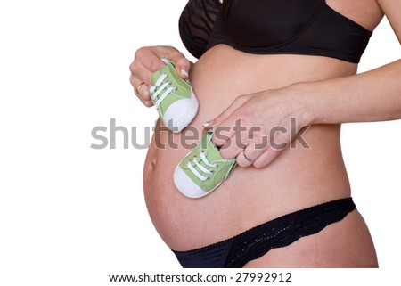Pregnant belly and little shoes closeup
