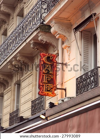 Stylish  neon Cafe sign in shopping district of Paris with open window and Balcony