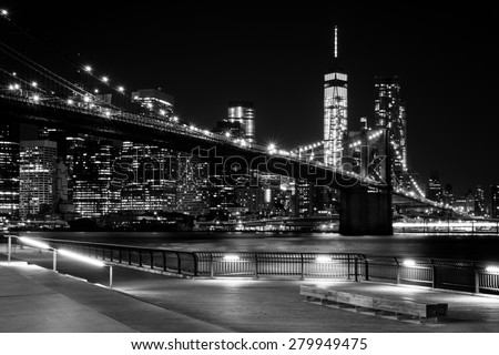 Brooklyn Bridge, Downtown Manhattan, New York. Night scene. Light trails. City lights. Urban living and transportation concept. Monochrome, black and white post processed