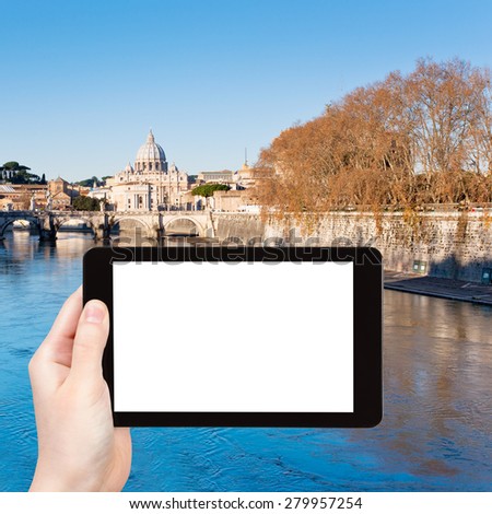travel concept - tourist photograph autumn view on Tiber river and St Peter Basilica in Rome, Italy on tablet pc with cut out screen with blank place for advertising logo