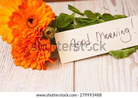 Orange flowers with good morning note