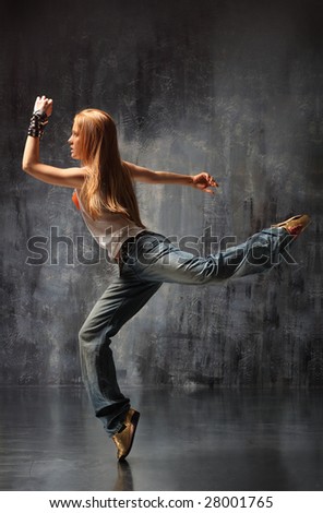 modern style dancer posing behind studio background