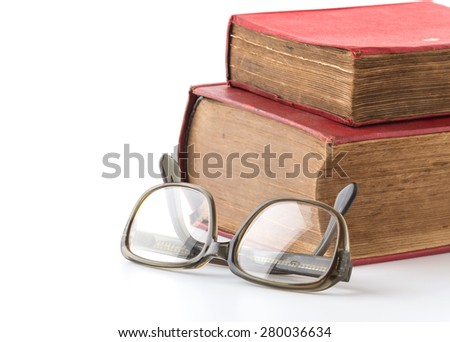 old book with glasses on white background