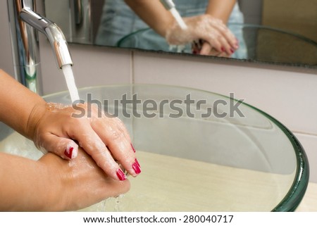 Hands washing with soap under running water, closeup