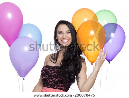 Attractive Young Smiling Brunette holding Colorful Balloons on White Background. Happy, bright and colorful image that can be used for parties, celebrations and happiness concepts