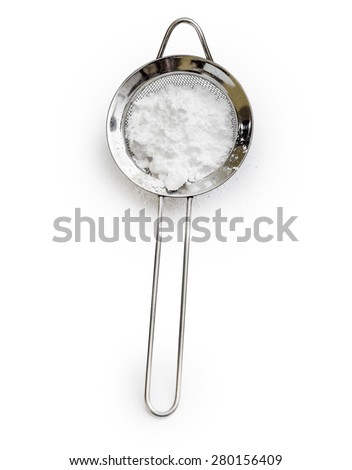 powdered sugar in a metal sieve with slotted spoon isolated on white background