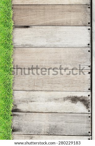 Green grass on wood background