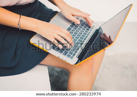 beautiful girl in a skirt and shirt working on laptop in cafe, apple style, macbook laptop