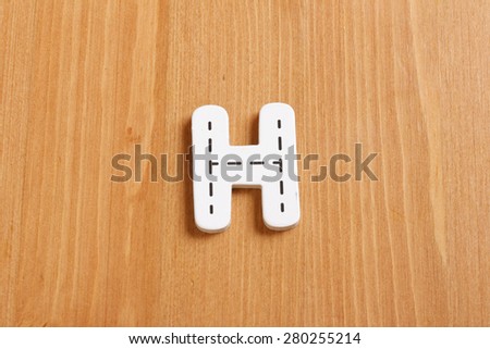 H, spell by woody puzzle letters with woody background