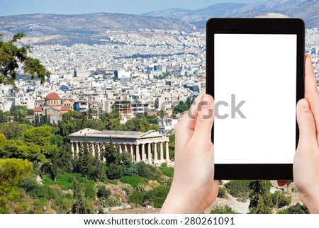 travel concept - tourist photograph Athens city with Temple of Hephaestus from Acropolis hill, Greece on tablet pc with cut out screen with blank place for advertising logo