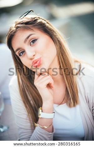 Pretty young caucasian girl sending a kiss
