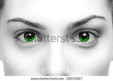 High contrast black & white close up of a womans eyes coloured green