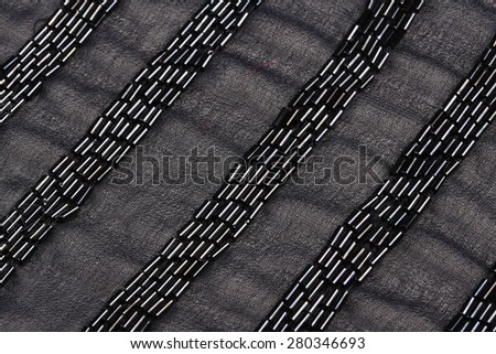 macro texture black pearls on a gray fabric studio