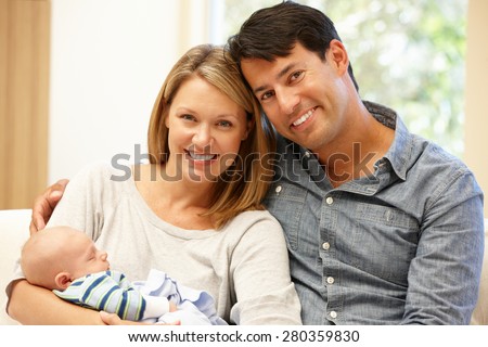 Couple at home with new baby