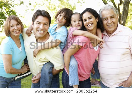 Multi Generation Hispanic Family Standing In Park Royalty-Free Stock Photo #280362254