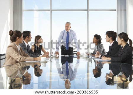 Group Of Business People Having Board Meeting Around Glass Table Royalty-Free Stock Photo #280366535