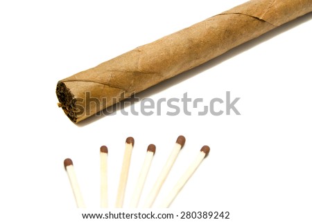 single cigar and few matches on white background closeup