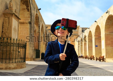 smart little boy taking selfie stick picture while travel in Europe, Malta