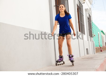 Good looking young woman skating in the city and having fun