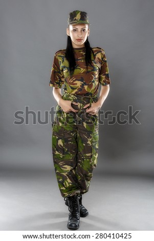 portrait of a woman soldier isolated on gray background