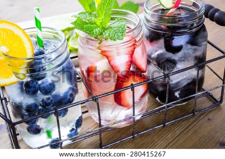 Infused water with fresh organic berries. Royalty-Free Stock Photo #280415267