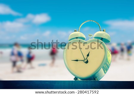old retro clock on sand beach ,vintage color tone,abstract background to memory of last time.