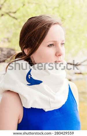 Portrait of a young woman in a white scarf with blue shark brooch 