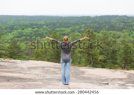 Woman girl standing on mountain looking at horizon and trees